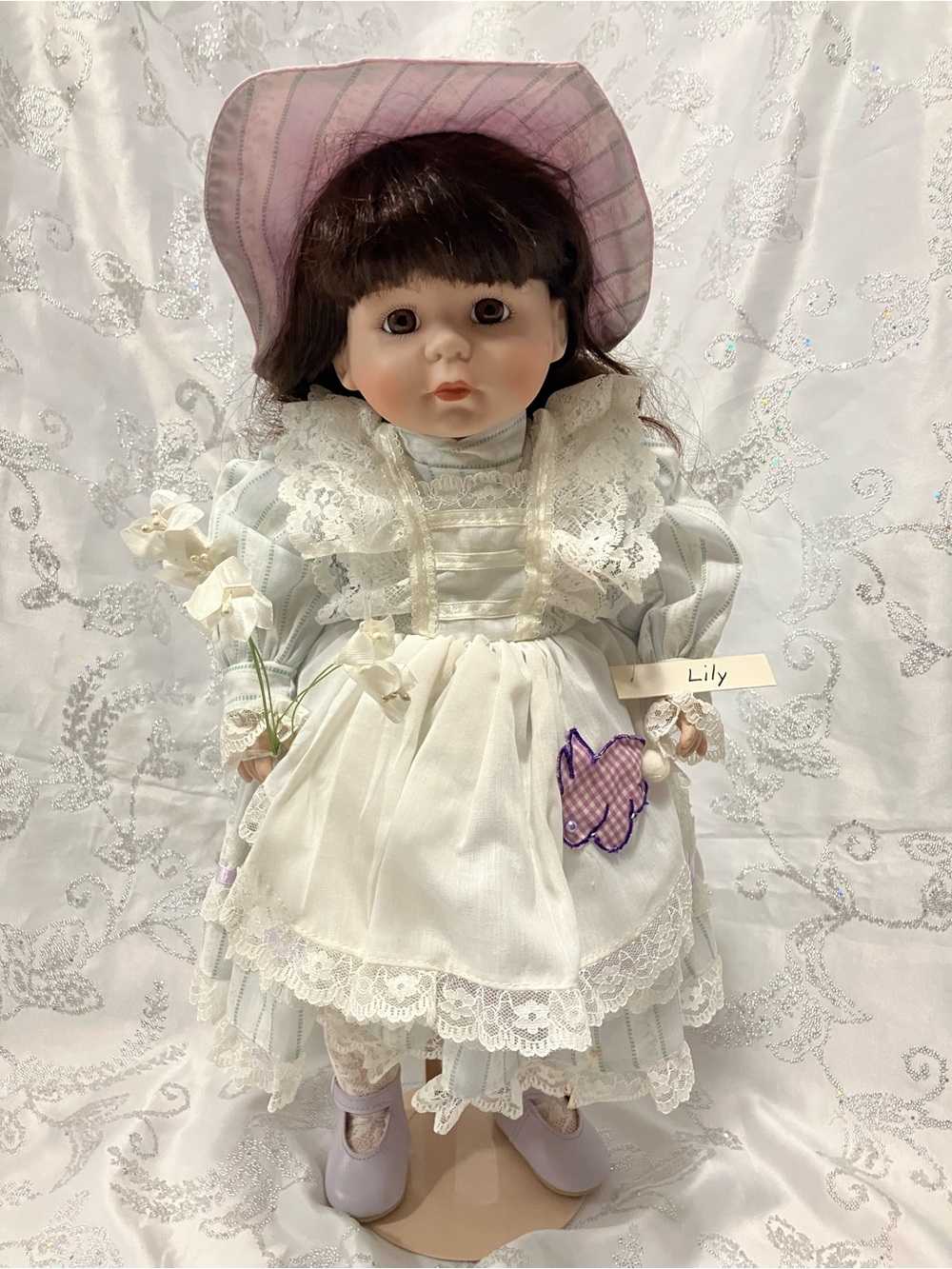 Collectible Porcelain Doll with Brown Hair and Lace Dress